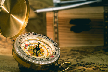 Compass with treasure chest close up