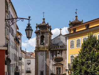 Fototapeta na wymiar Old church tower of Sao Bartholomeu church in downtown Coimbra in Portugal