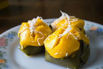 Toddy Palm Cake (Thai language : Kanom Tarn) with white coconut It is a Thai dessert made from Toddy palm and packaging from banana leaf