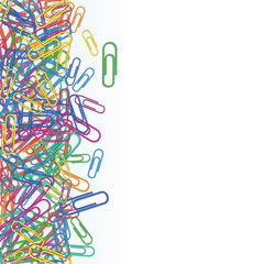 Heap of plastic multi colored paper clips isolated on white background. Design element for banner, school supplies. Stationery and office supply. Border with copy space.