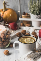 autumn cosy pumpkin, candles and autumn plants on window with led lights bokeh