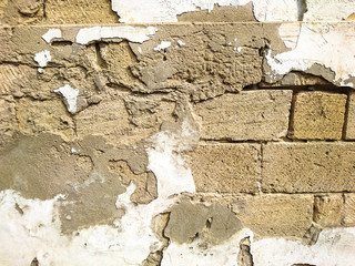 Background texture image of crumbling wall of an old house