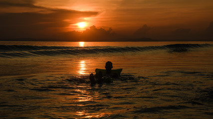 silhouette of man on beach at sunset