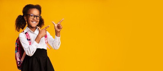 Black School Girl Pointing Fingers Aside At Empty Space, Panorama