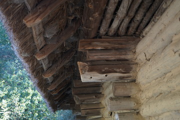 Old wooden house with thatched roof. Thatched roof of the house. Close-up.