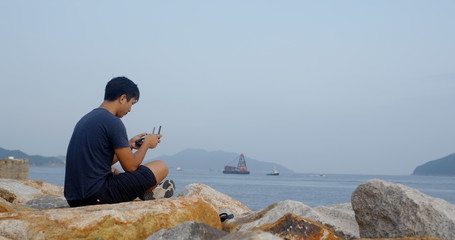 Asian man control with fly drone