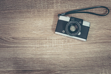 Vintage film camera on wooden table.