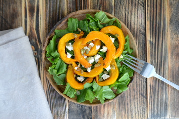 Warm autumn pumpkin salad with seeds and soft cheese Healthy food concept