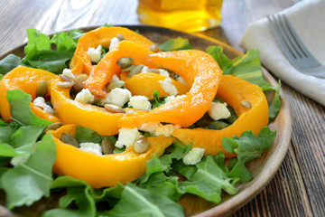 Warm autumn  pumpkin salad with seeds and soft cheese Healthy food concept