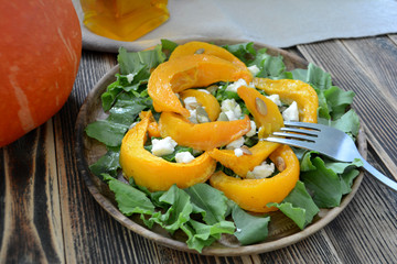Warm autumn  pumpkin salad with seeds and soft cheese Healthy food concept