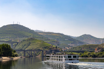 Touristic cruise going up river, taking tourists to see terraces and vineyards