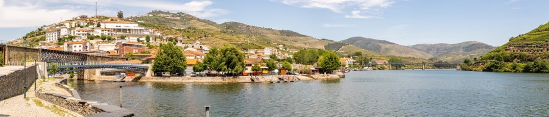 Fototapeta na wymiar Pinhão village at Alto Douro Vinhateiro, Douro River, bridge and vineyards