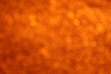 background of gold and orange glitter lights. de focused