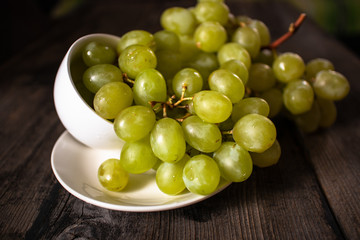 Fresh organic white grape on old wooden table