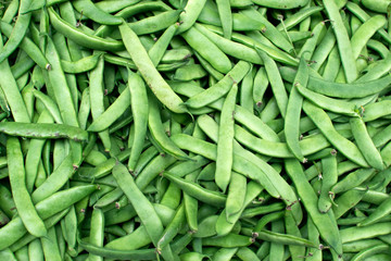 Green pea pods, top view background