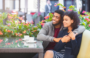 Obraz premium Lovely black couple spending time together at terrace