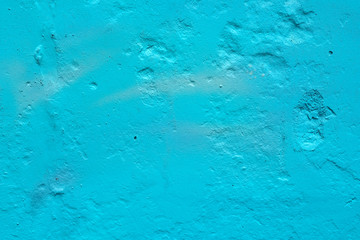texture of a painted wall. cement plate blue color background. wall with bumps and small pits.