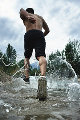 Asian athlete on a morning run on the river, Kazakh jogger in nature close-up
