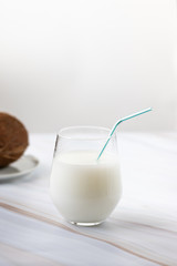 brown coconut with straw, tropical refreshing drink. Coconut milk