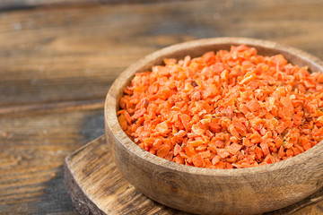 Dried carrots in a wooden bowl on a wooden table. Soup seasoning