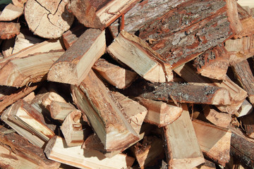 A pile of chopped firewood. Close-up. Background. Texture.