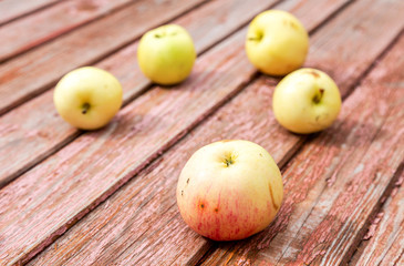 Naklejka na ściany i meble Apples on the weathered wooden table background