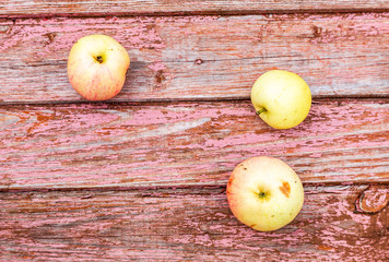 Apples on the weathered wooden table background