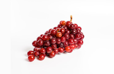 A bunch of red grapes on a white background