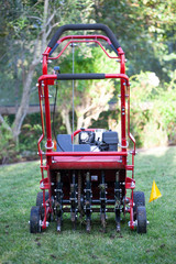 Red grass lawn aerator