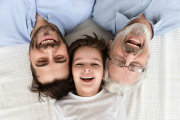 Happy three generation family lying in row, portrait, closeup view