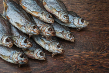 some dried fish on a dark wooden background