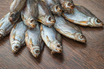 some dried fish on a dark wooden background