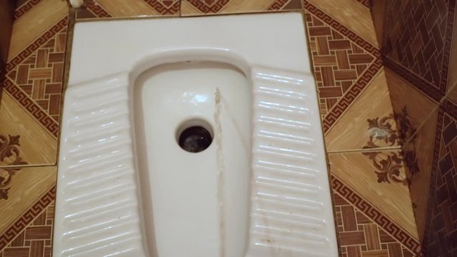man pees in toilet, first-person view, stream of urine flies into toilet.