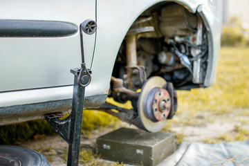 Fototapeta premium wheel replacement, the machine is lifted on a jack. breakdown on the road.