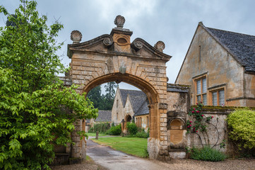 Fototapeta na wymiar STANWAY, ENGLAND - MAY, 26 2018: Stanway Manor House built in Jacobean period architecture 1630 in guiting yellow stone, in the Cotswold village of Stanway, Gloucestershire, Cotswolds, UK 