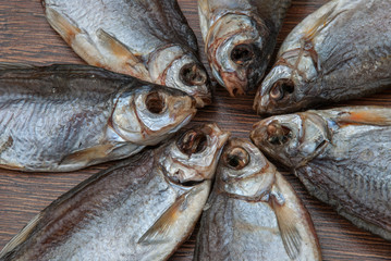 some dried fish on a dark wooden background