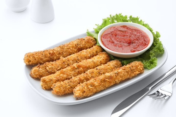 breaded mozzarella cheese sticks fried and served with  sauce on white back 