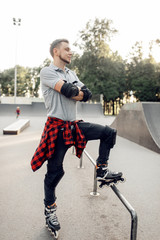 Roller skating, young skater poses in skate park