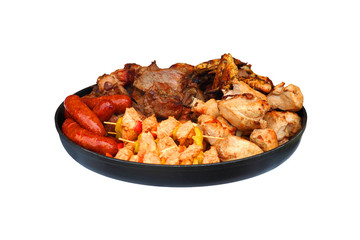 Barbecue concept. Set of meat products cooked on fire. Grilled beef, lamb, pork, skewers, chicken wings, sausages on a large skillet isolated on white background. Kebab