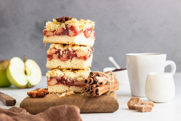 Crumble cakes with apple, red berry jam and spices filling and a cup of coffee. Autumn breakfast or dessert.