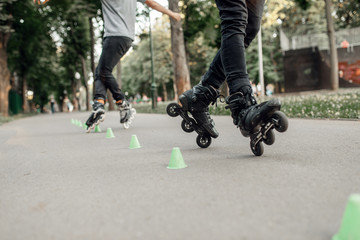 Roller skating, two skaters rolling around cones