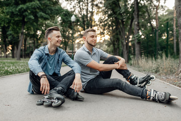 Roller skating, two skaters sitting on the ground