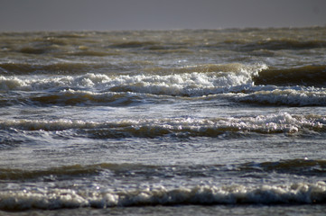 Waves lashing the shore on a windy day