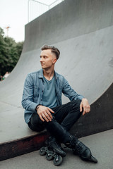 Roller skating, male skater poses on the ramp