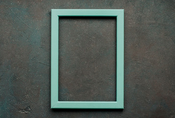  Blue wooden frame on a rough dark textured background. mock up