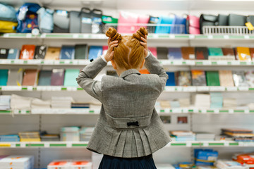 School girl in stationery store, back view