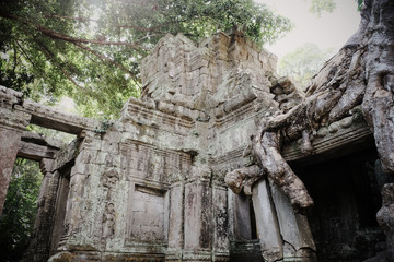 The ruins of medieval stone buildings in Cambodia. Dilapidated old buildings.