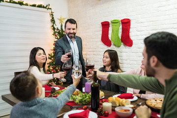 Man Toasting Drinks After Speech At Home During Christmas