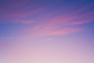 Crimson sunset with clouds. Magenta sky background. Purple clouds and blue sky