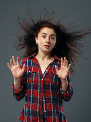 Strong fan blowing in female face, funny emotion